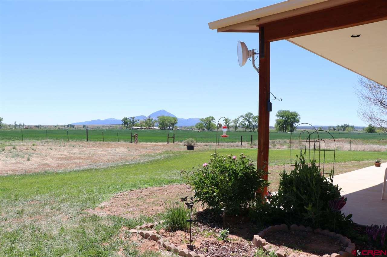 23720 County Rd M Cortez, CO 81321 - Photo 8 of 34 a view of a lake with a big yard