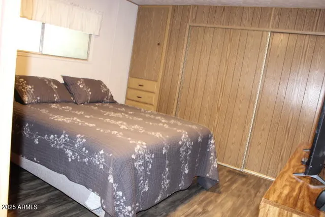 a large bed sitting in a bedroom next to a window