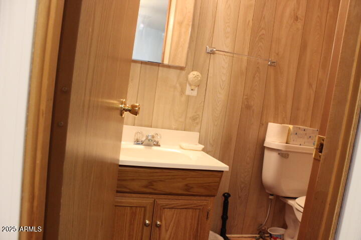 11425 East University Drive, Unit 63 Apache Junction, AZ 85120 - Photo 12 of 30 a bathroom with a sink a toilet and a mirror