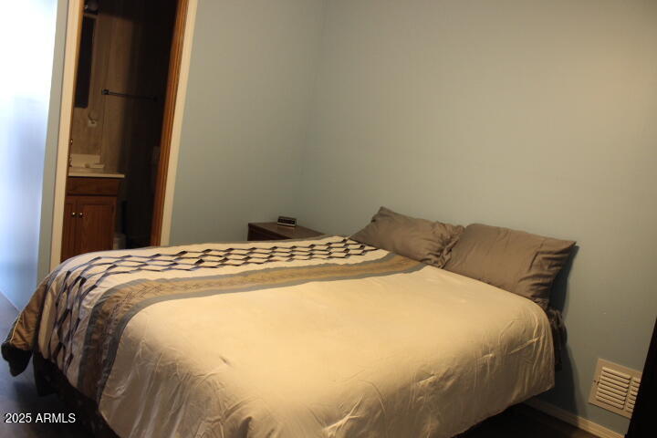 11425 East University Drive, Unit 63 Apache Junction, AZ 85120 - Photo 14 of 30 a bed sitting in a bedroom next to a window