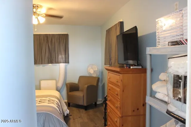 a bedroom with furniture and a flat screen tv