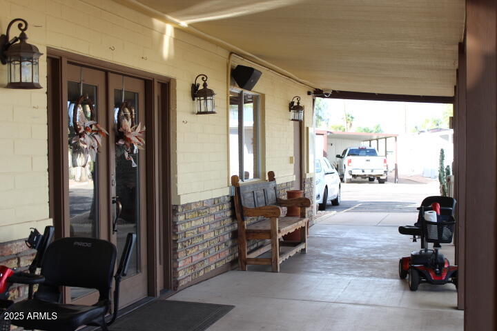 11425 East University Drive, Unit 63 Apache Junction, AZ 85120 - Photo 24 of 30 a living room with furniture a rug and a large window
