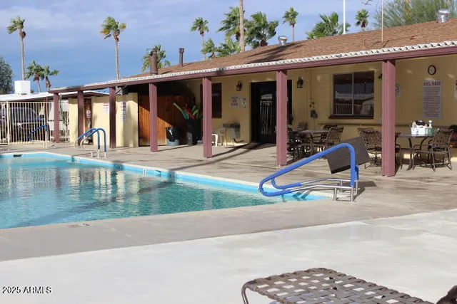 a view of a tennis ground with a large building in the background