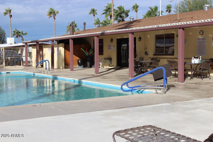 11425 East University Drive, Unit 63 Apache Junction, AZ 85120 - Photo 27 of 30 a view of a house with a patio and a yard