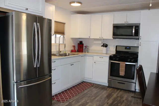 a kitchen with a refrigerator stove and sink