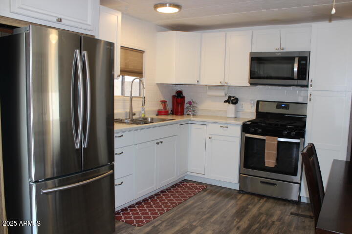 11425 East University Drive, Unit 63 Apache Junction, AZ 85120 - Photo 5 of 30 a kitchen with a refrigerator stove and sink
