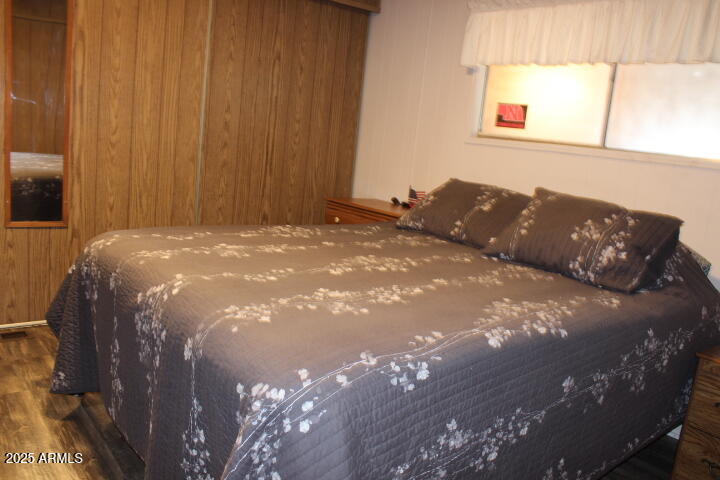 11425 East University Drive, Unit 63 Apache Junction, AZ 85120 - Photo 10 of 30 a bed sitting in a bedroom next to a window