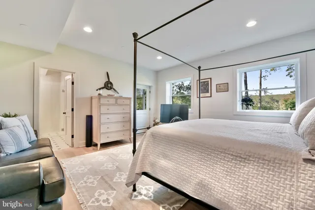 a bedroom with a large bed closet and window