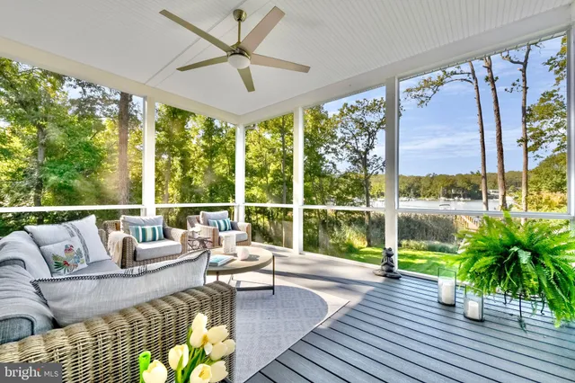 a living room with furniture and floor to ceiling windows