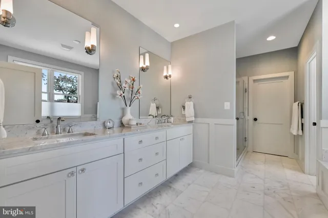a spacious bathroom with double sink and mirror