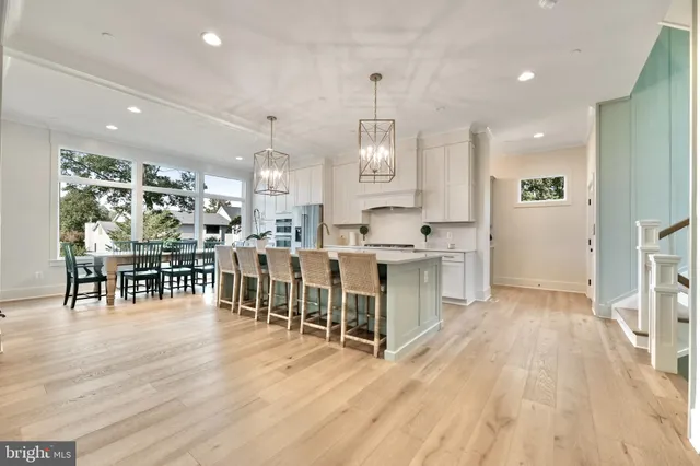 a large white kitchen with lots of counter space a sink and appliances