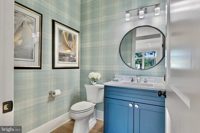 a bathroom with a toilet a sink and mirror
