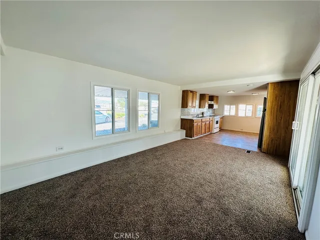 a living room with a walk in closet and a window