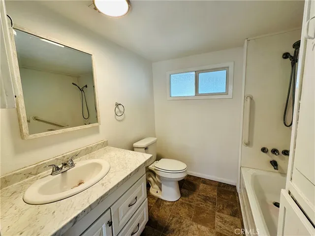 a bathroom with a sink toilet tub and shower