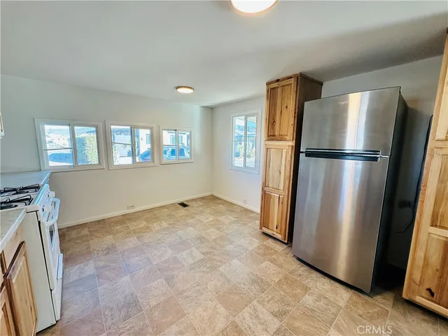 a view of a refrigerator in kitchen and livingroom