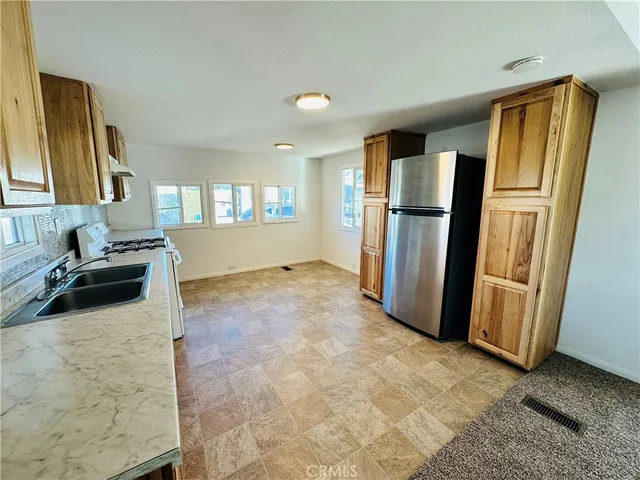 a kitchen with a refrigerator and a sink