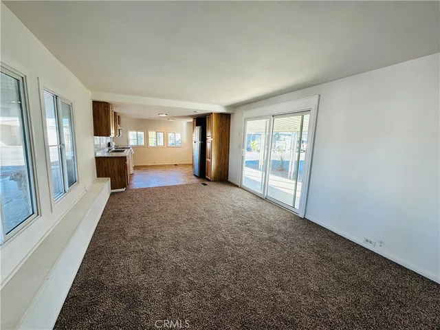 an empty room with large windows