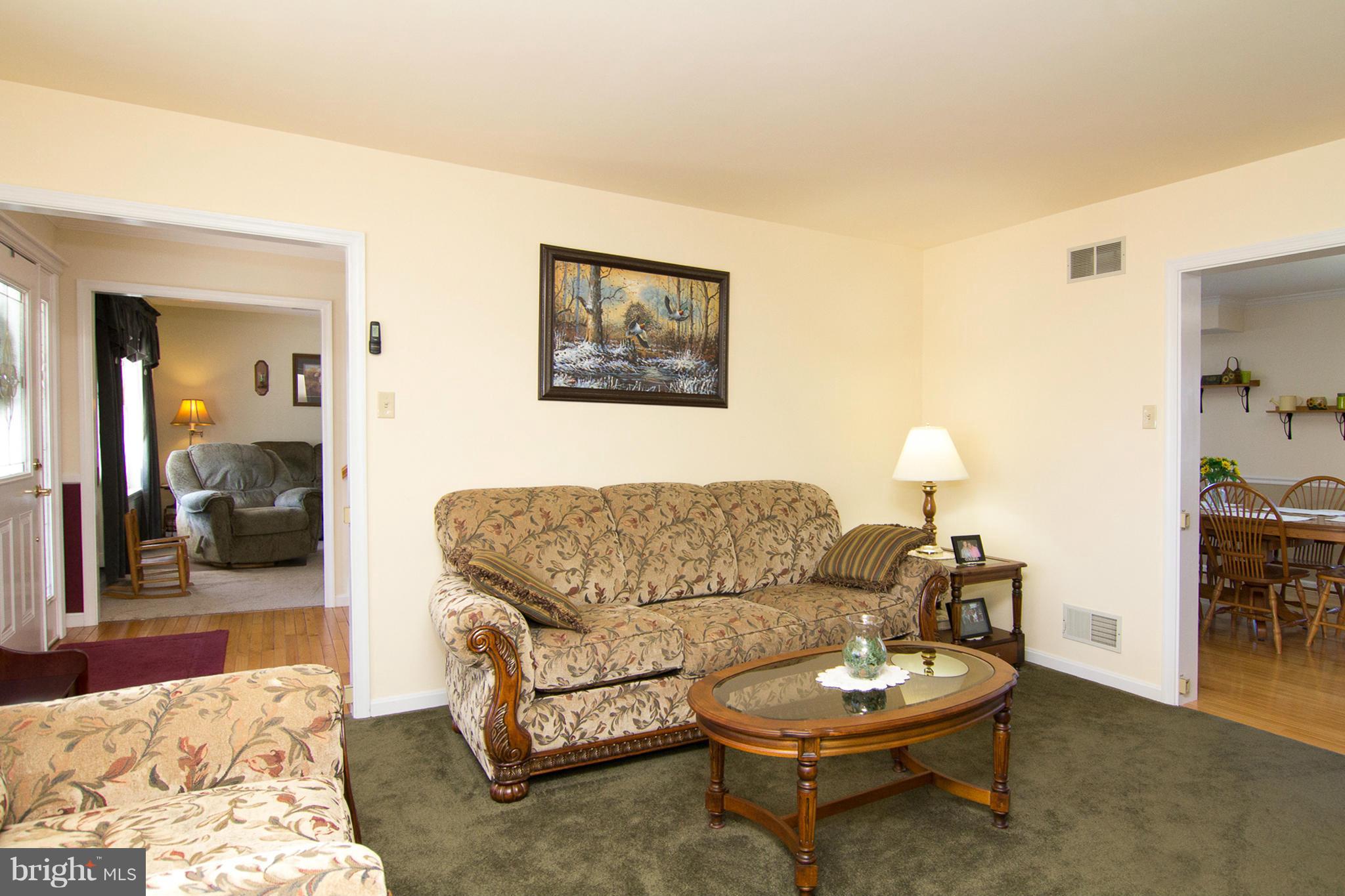 3773 Baptist Road Taneytown, MD 21787 - Photo 11 of 30 a living room with furniture a mirror and a lamp on table