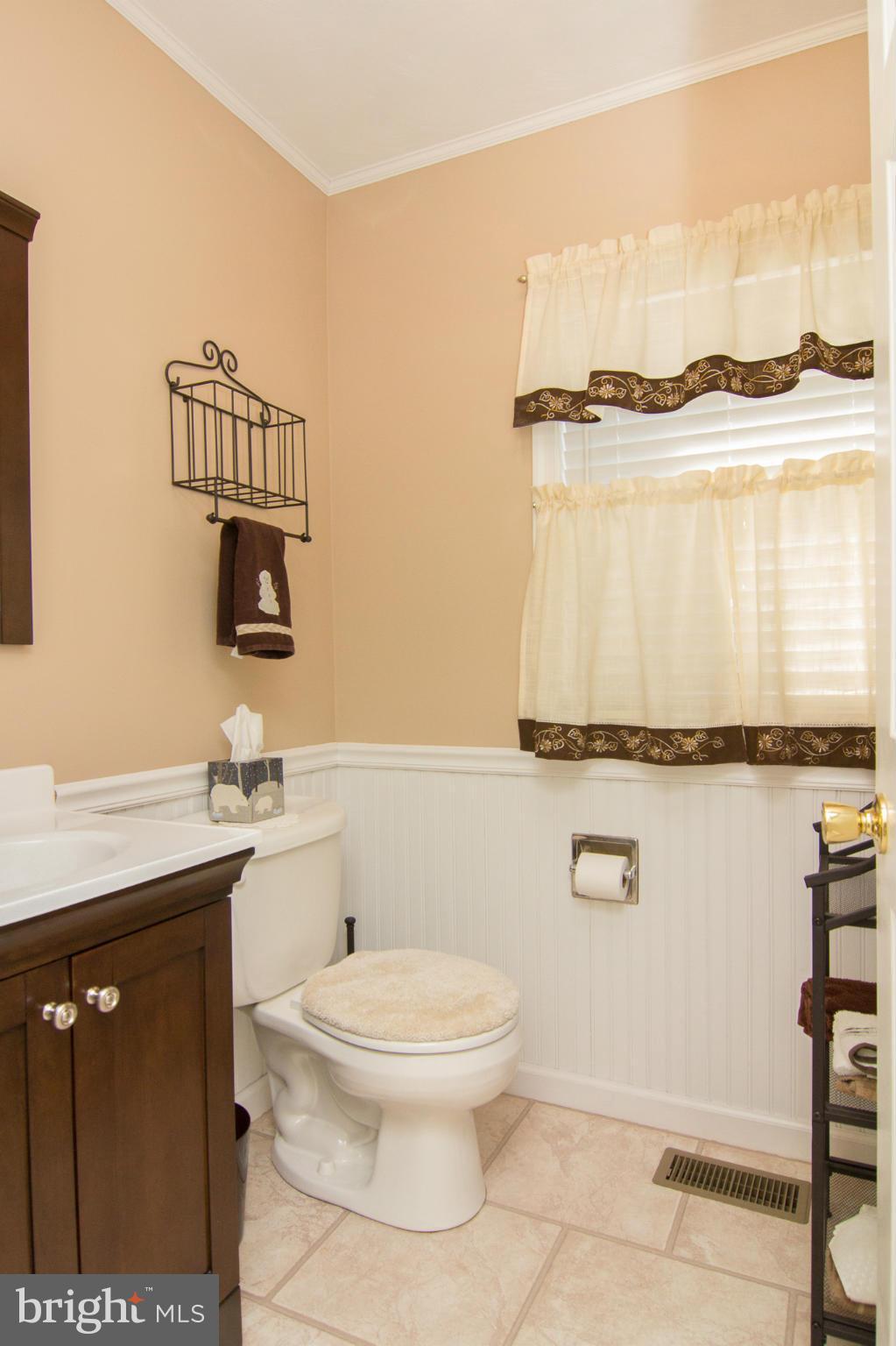 3773 Baptist Road Taneytown, MD 21787 - Photo 13 of 30 a bathroom with a toilet a sink and mirror
