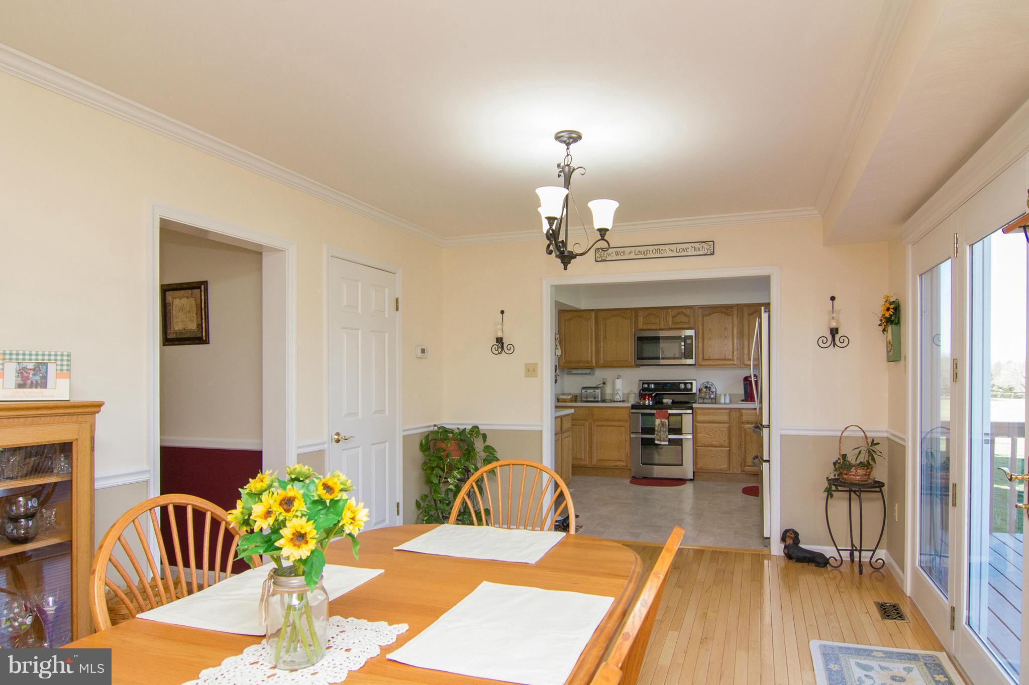 3773 Baptist Road Taneytown, MD 21787 - Photo 14 of 30 a view of a dining room with furniture a chandelier and wooden floor