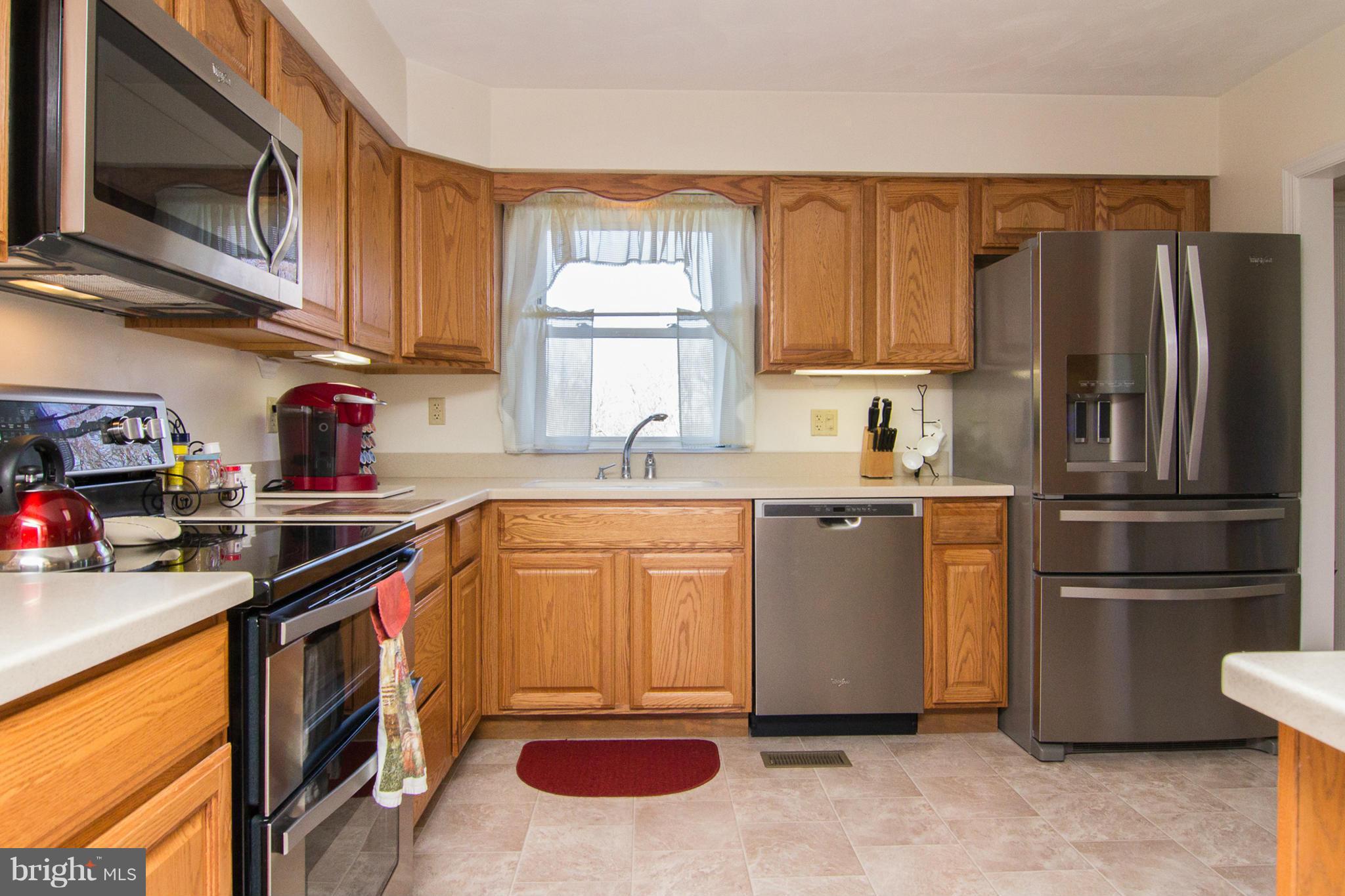 3773 Baptist Road Taneytown, MD 21787 - Photo 15 of 30 a kitchen with stainless steel appliances granite countertop a refrigerator stove and sink