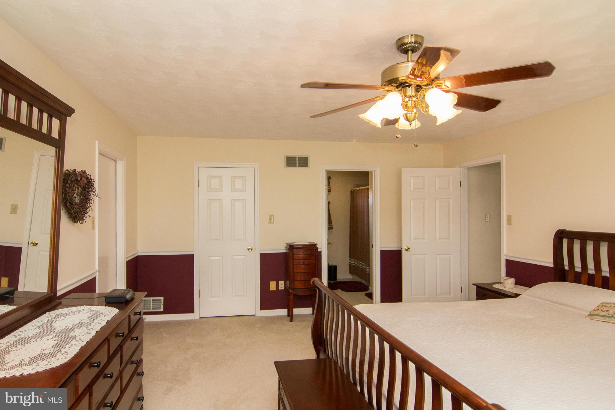 3773 Baptist Road Taneytown, MD 21787 - Photo 17 of 30 a bedroom with a bed and a chandelier
