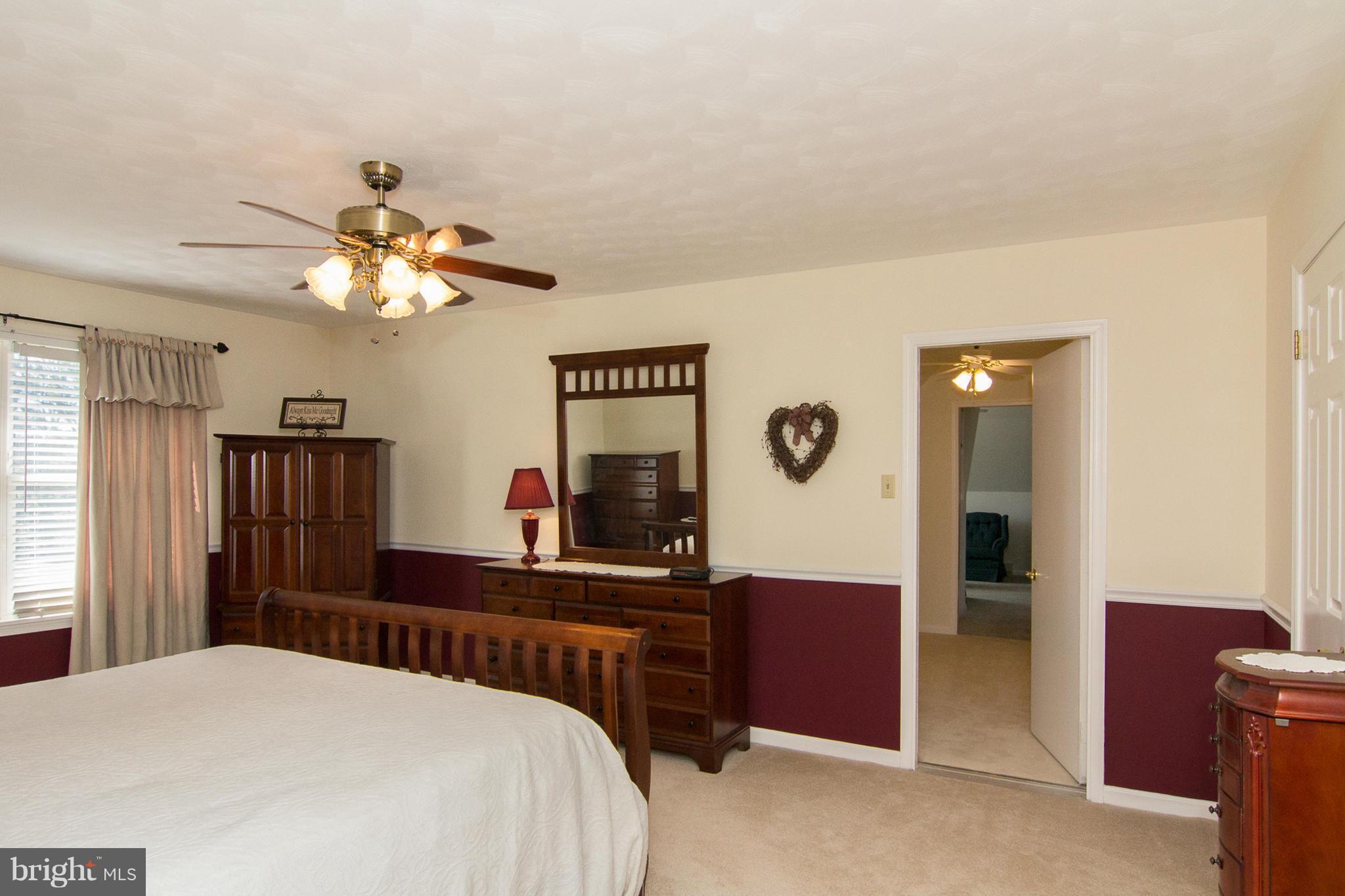 3773 Baptist Road Taneytown, MD 21787 - Photo 19 of 30 a bedroom with a bed and a chandelier