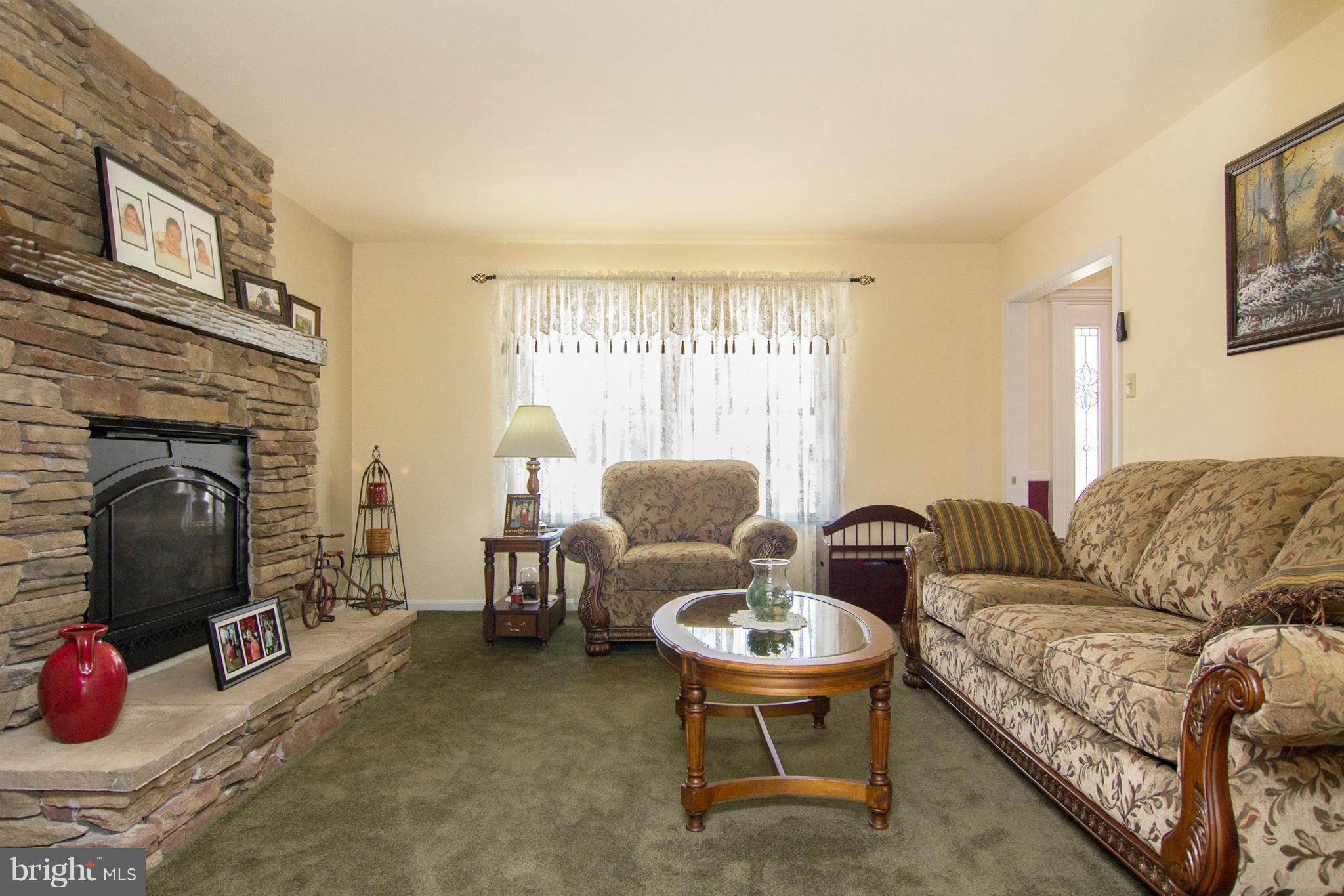 3773 Baptist Road Taneytown, MD 21787 - Photo 5 of 30 a living room with furniture a fireplace and a flat screen tv