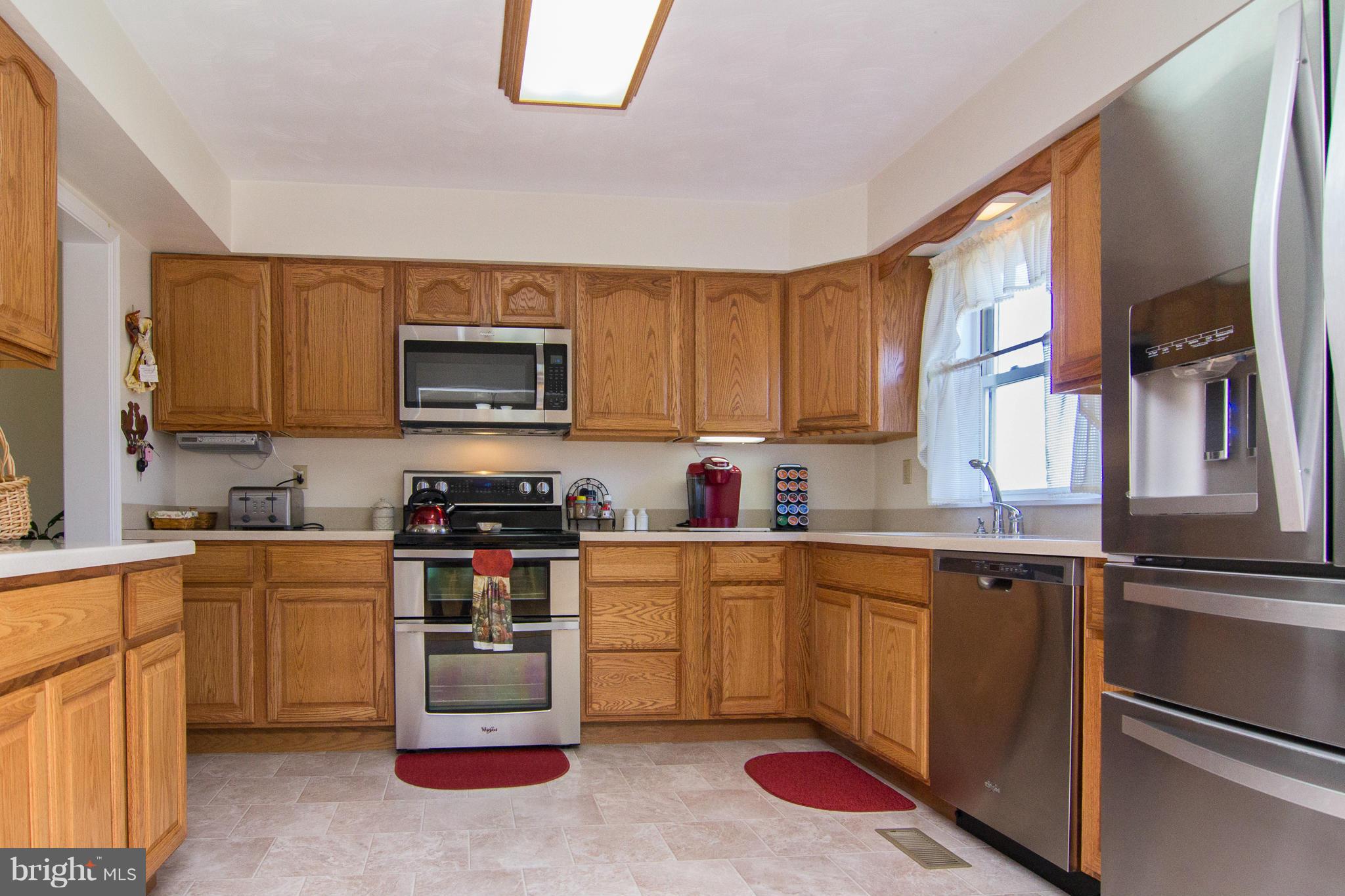 3773 Baptist Road Taneytown, MD 21787 - Photo 6 of 30 a kitchen with stainless steel appliances granite countertop a stove top oven a sink dishwasher and cabinets with wooden floor