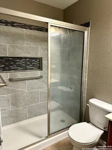 a bathroom with a shower and a toilet