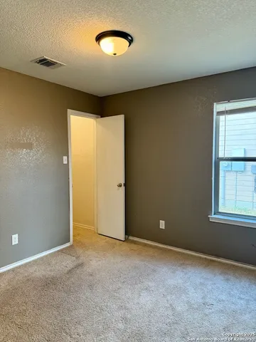 an empty room with windows and closet