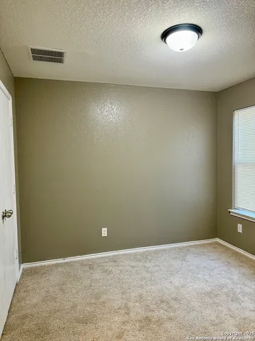 an empty room with a empty space and a window