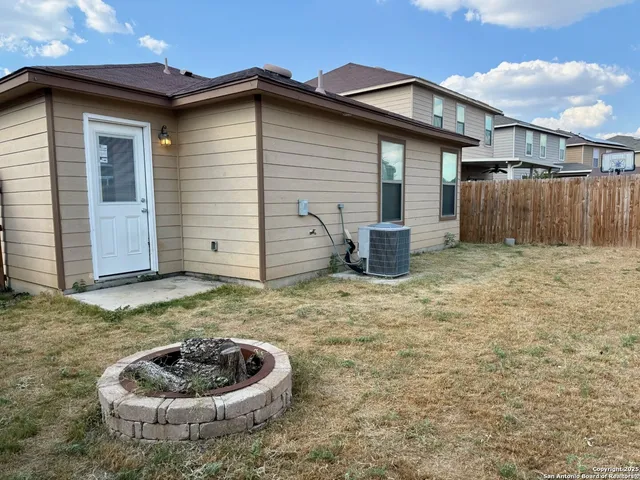 a backyard of house with a fountain
