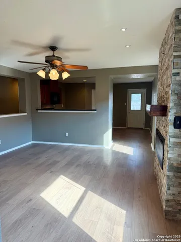 a view of a livingroom with a fireplace and a window