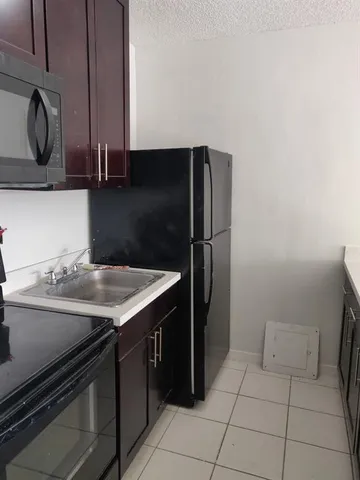 a kitchen with a sink cabinets and stainless steel appliances