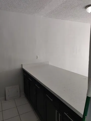 a room with a sink and cabinets