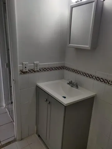 a bathroom with a sink and mirror