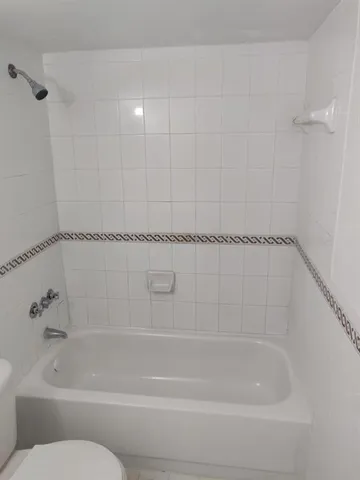 a bathroom with a toilet a sink and bathtub