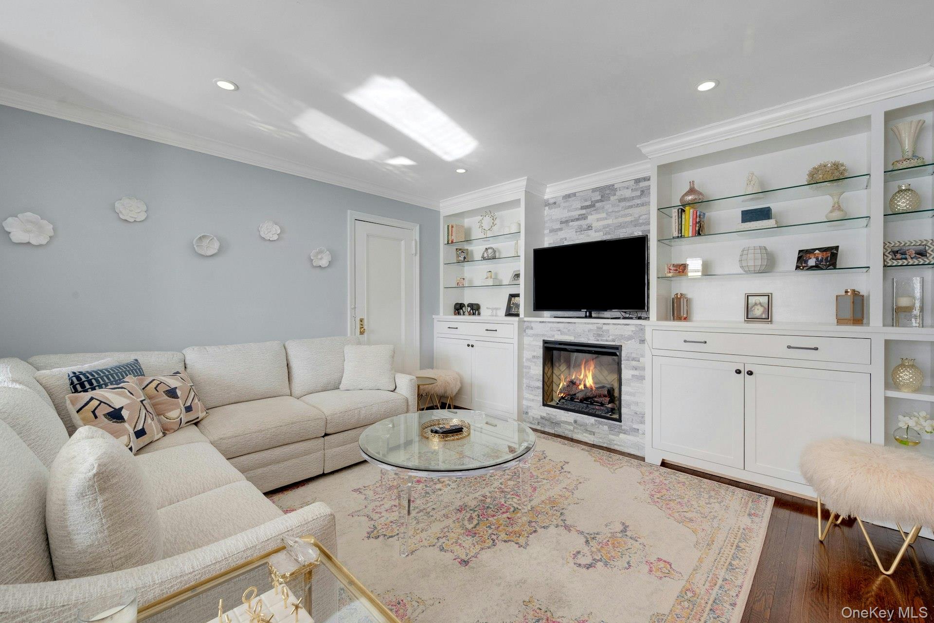 280 Bronxville Road, Unit 3W Bronxville, NY 10708 - Photo 6 of 19 a living room with furniture a fireplace and a flat screen tv