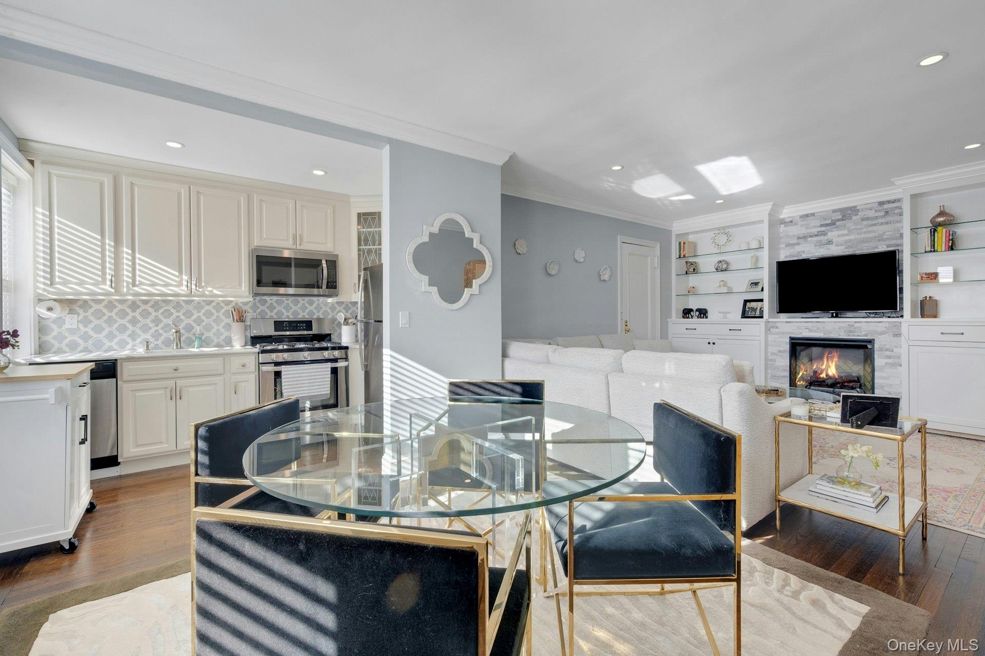 280 Bronxville Road, Unit 3W Bronxville, NY 10708 - Photo 10 of 19 a kitchen with kitchen island granite countertop a table chairs microwave and cabinets