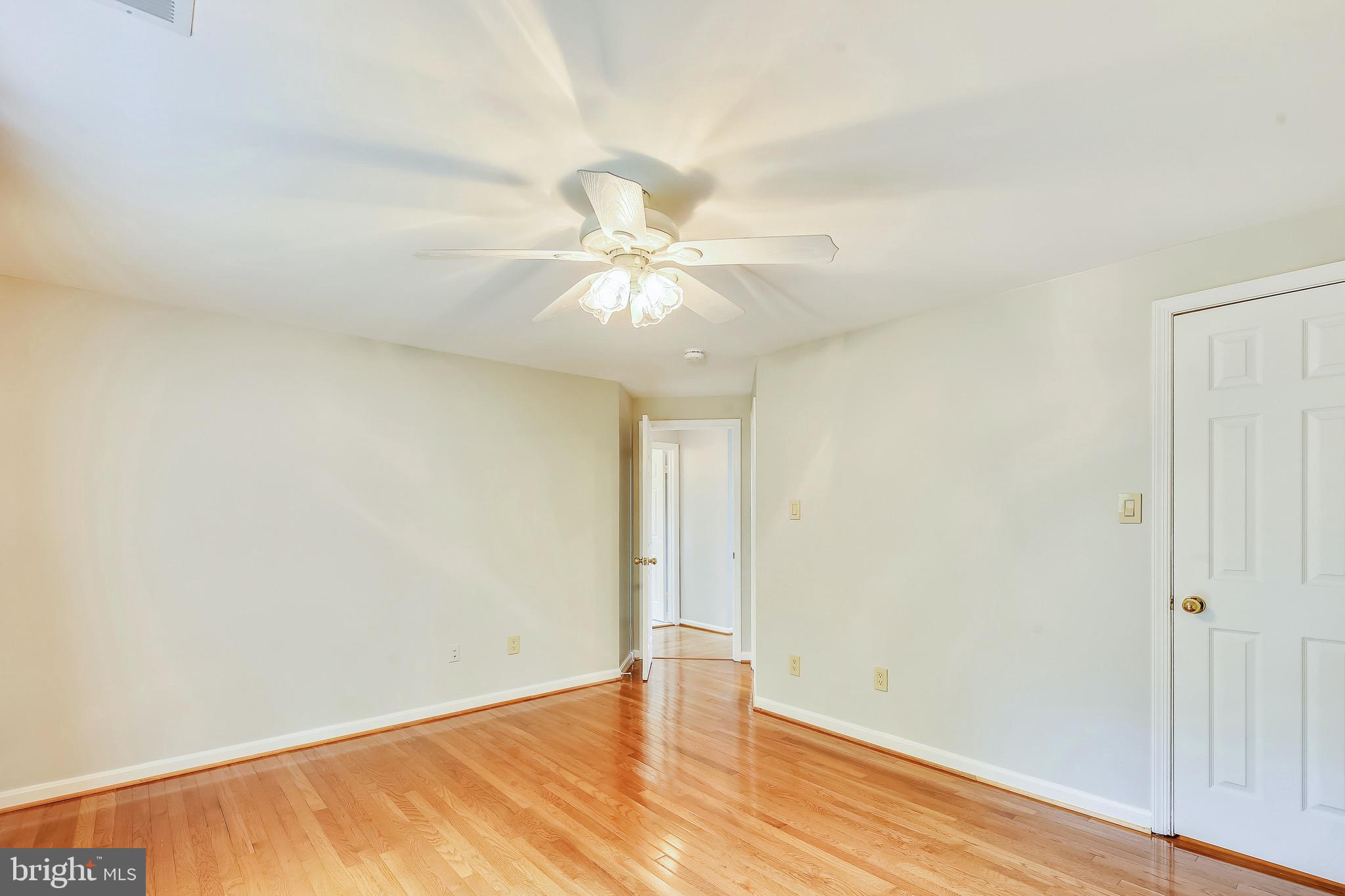 1530 Deer Point Way Reston, VA 20194 - Photo 17 of 42 an empty room with wooden floor and fan