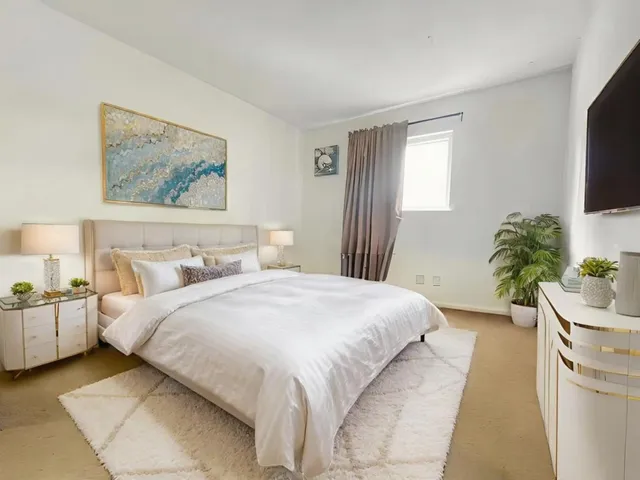 a bedroom with a bed and a flat screen tv