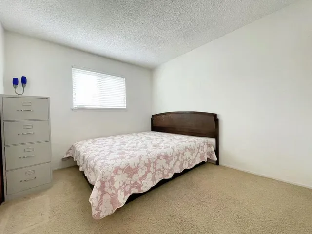 a bedroom with a bed and window
