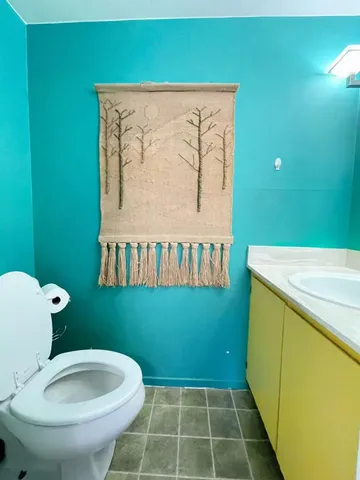 a bathroom with a toilet and a sink