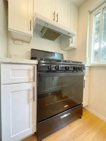 a stove top oven sitting inside of a kitchen