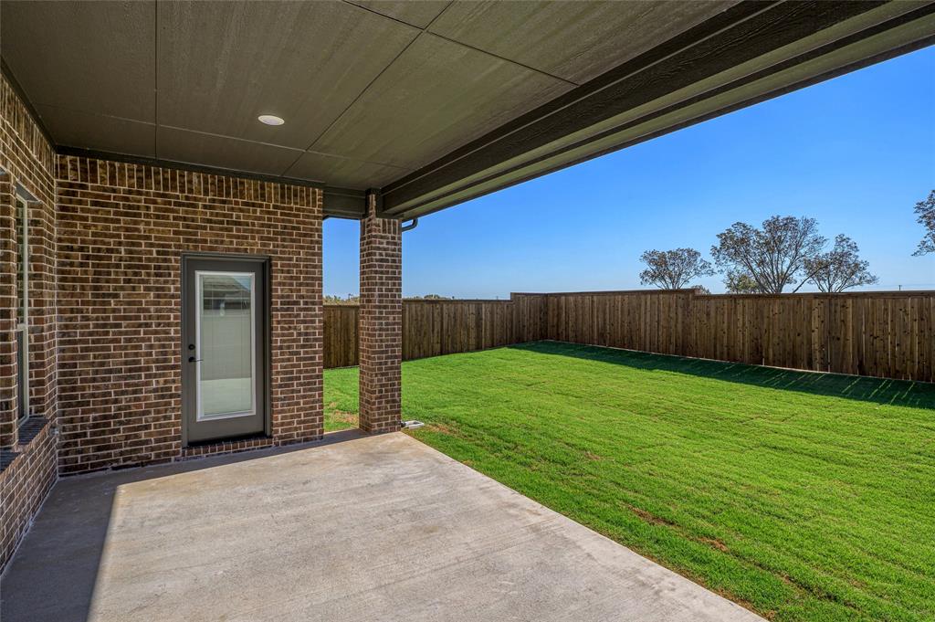 613 Brazos Drive Van Alstyne, TX 75495 - Photo 28 of 29 Fenced backyard with a patio