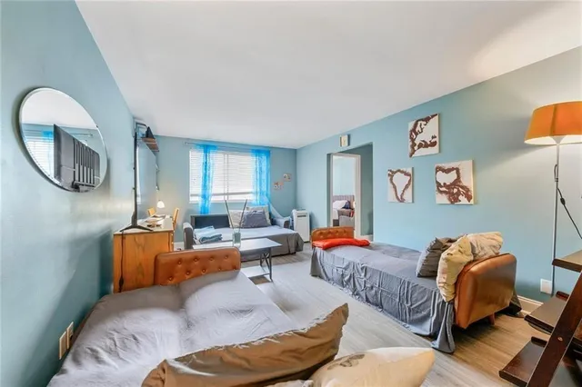 a living room with furniture and a mirror