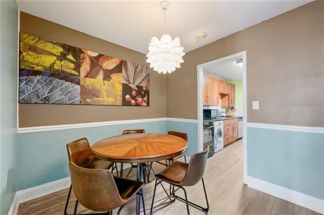 a view of a dining room with furniture and chandelier