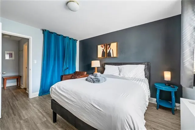 a bedroom with a bed and wooden floor