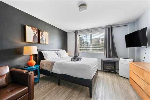 a bedroom with a bed and a flat screen tv